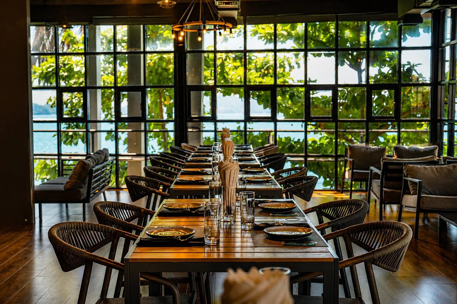 Elegant set dining table at Marush with garden and sea views.